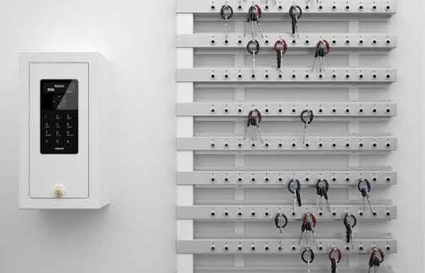 Woman selects a key from a Key Box System